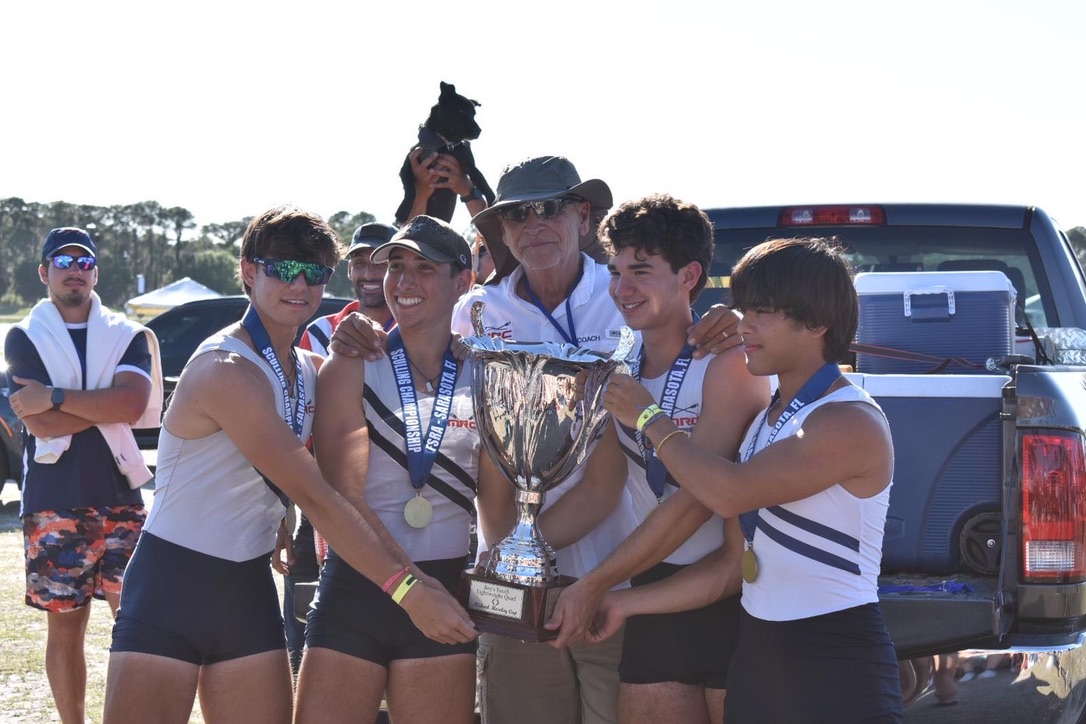 Holding a rowing trophy